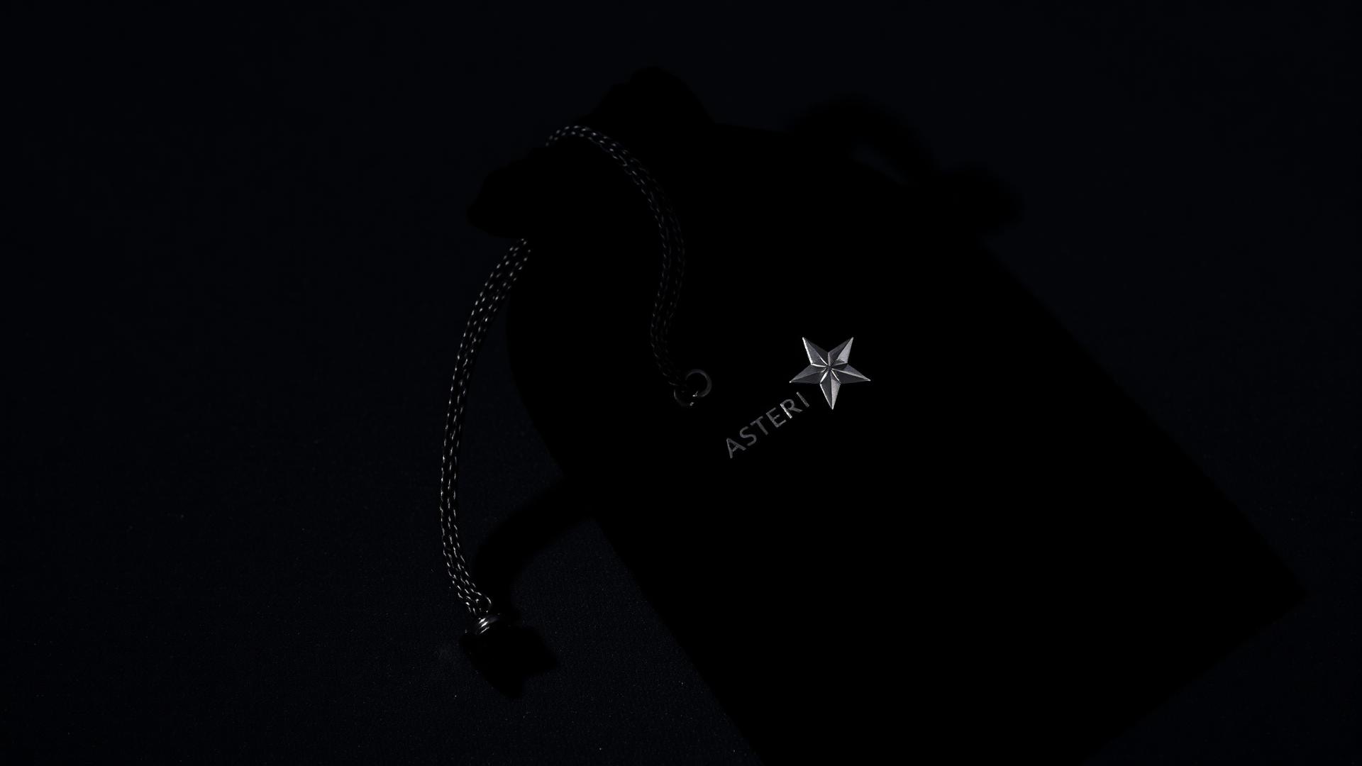 Black velvet pouch with silver Asteri star embroidered emblem